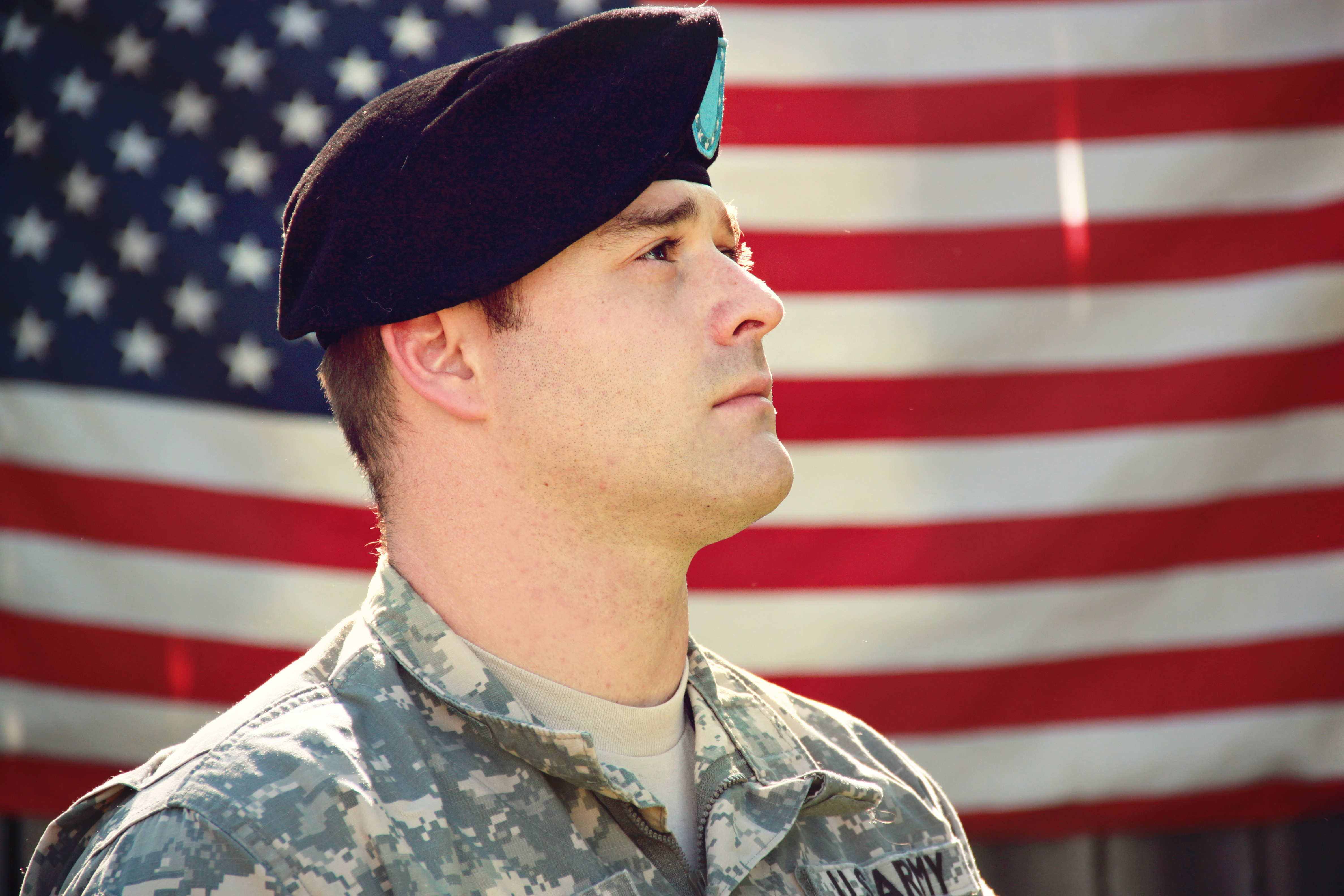 Canva - Man Wearing Combat Hat And Top Looking Up Near Flag Of America